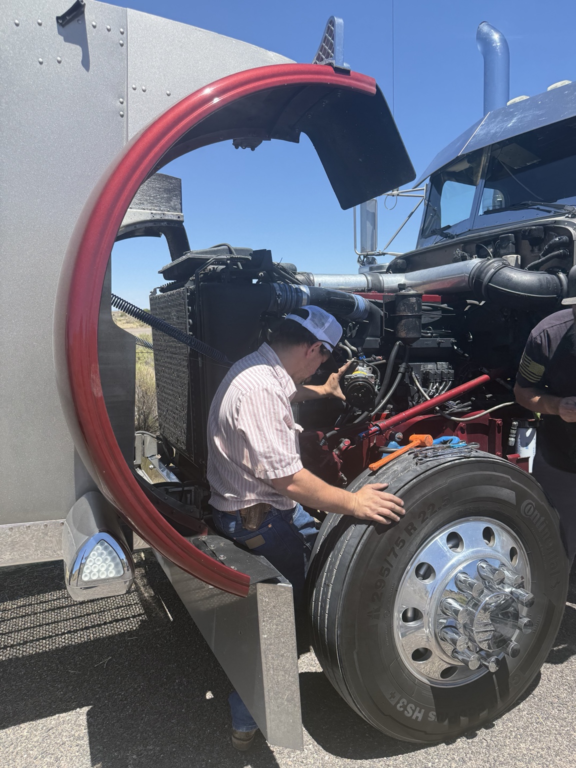 Diesel repair being performed on a semi truck in the field